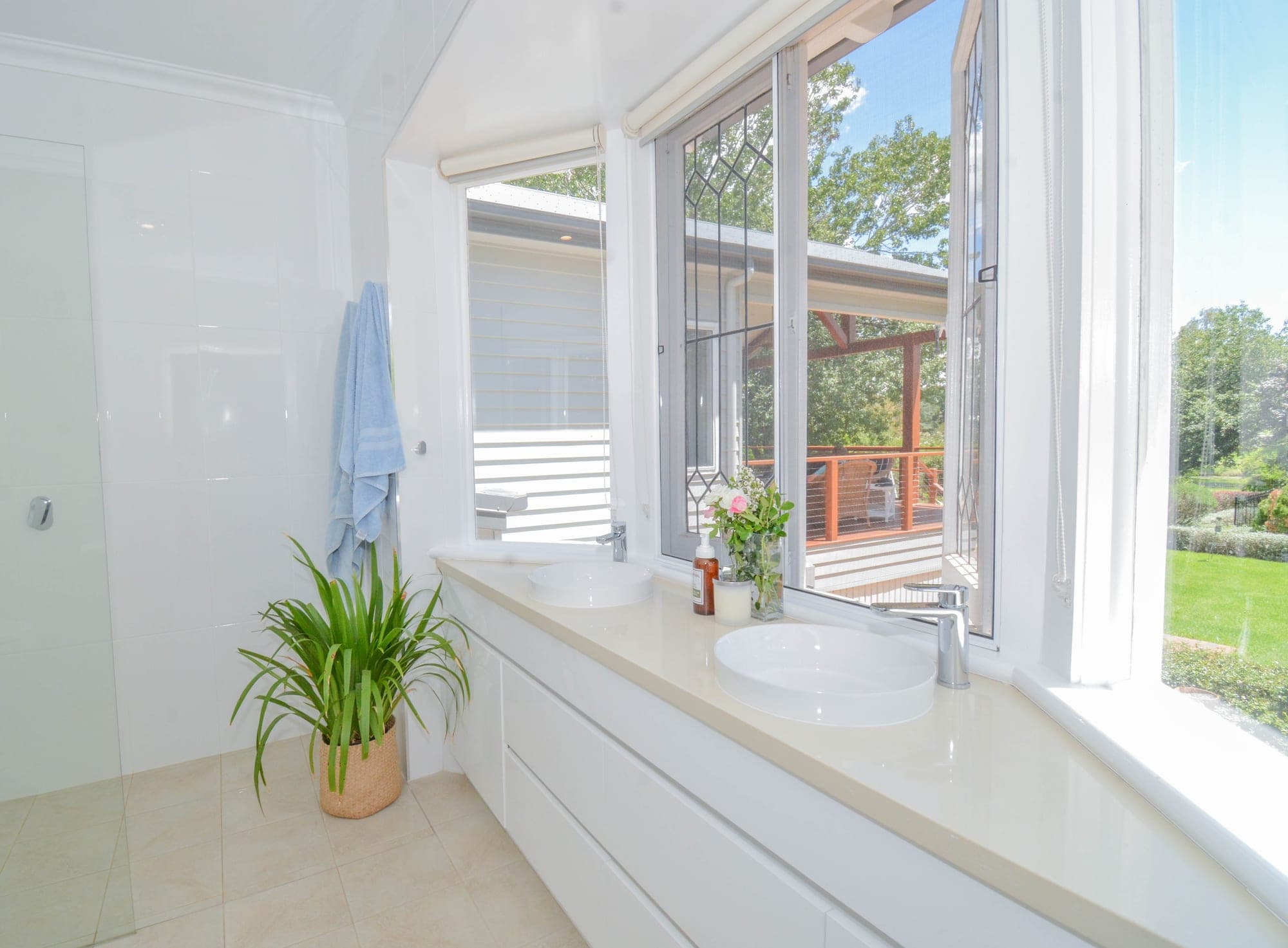 Ensuite bathroom with freestanding bath, large format tile and pendant lighting