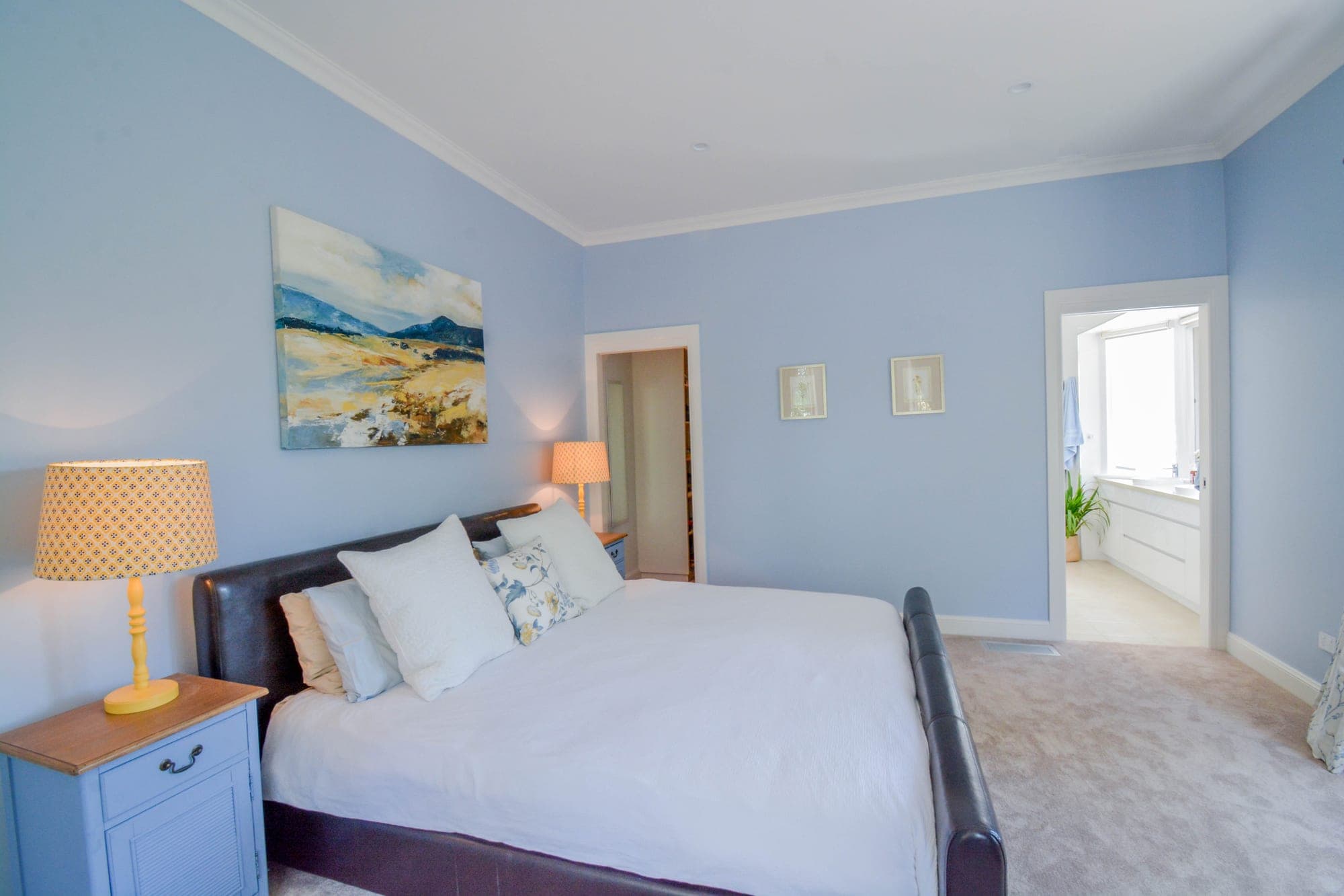Master bedroom with vaulted ceiling, timber beams and natural light