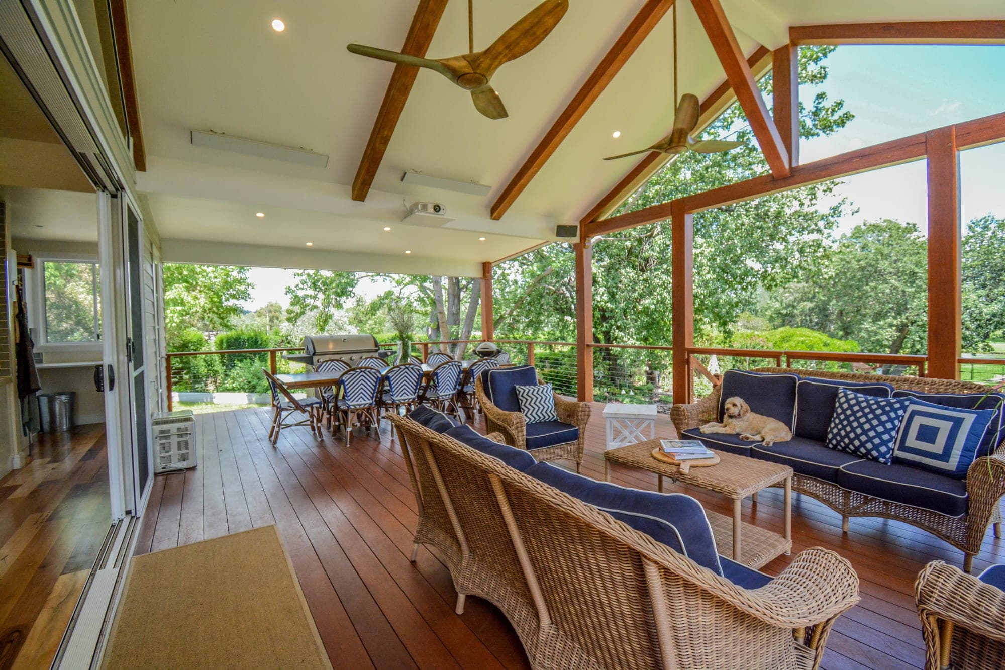 Expansive outdoor entertaining deck with timber structure, rural property views beyond